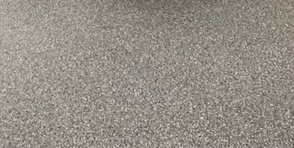 Gray patterned concrete garage floor finish with flecks.