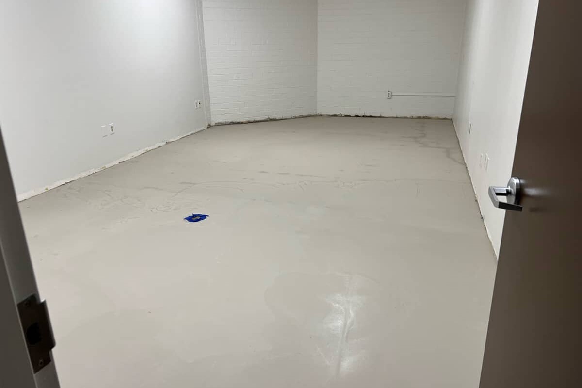 Empty room with new beige subfloor.