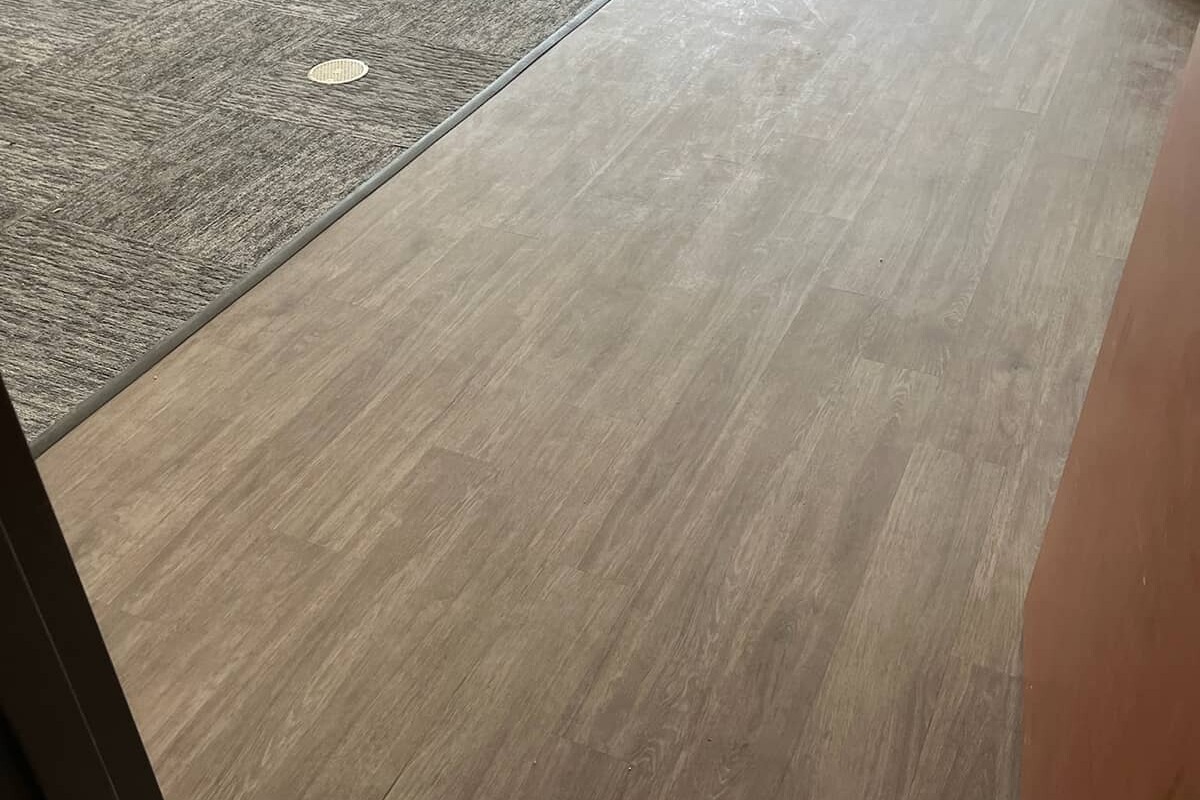 Brown patterned carpet and vinyl commercial office flooring.