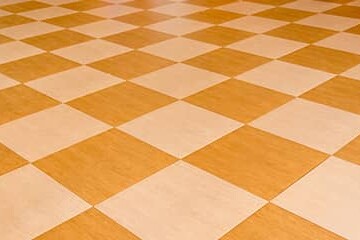 Vinyl composition tile in an orange checkerboard pattern.
